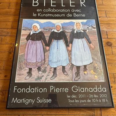 Sale Photo Thumbnail #230: Large framed art exhibit poster featuring traditional Swiss dress. From Fondation Pierre Gianadda, dated 2011–2012.