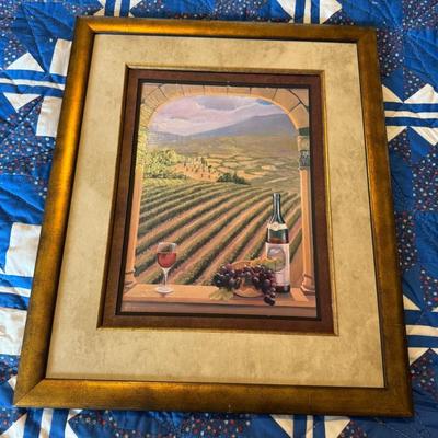 Sale Photo Thumbnail #303: Scenic framed print showing a vineyard view with wine bottle and glass. Rustic gold-tone frame with double mat.