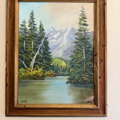 Sale Photo Thumbnail #306: Framed oil painting of a serene alpine lake and mountain scene. Rich greens and blues.
