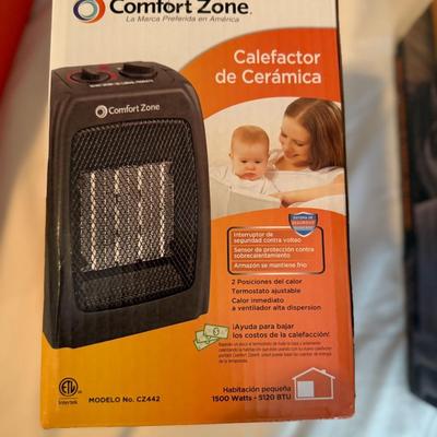 Sale Photo Thumbnail #348: Compact 1500W ceramic space heater with safety features, adjustable thermostat, and two heat settings. Perfect for small rooms