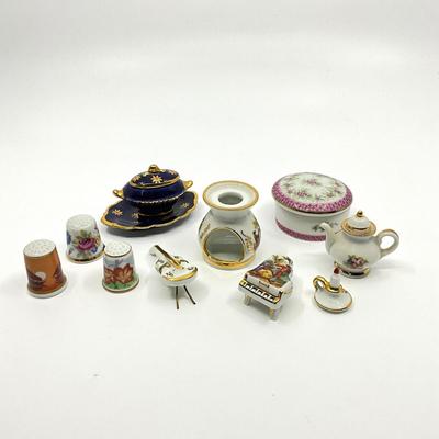 Sale Photo Thumbnail #645: 1930 mini-cello with stand, candlestick, 3 thimbles, Tart holder, Trinket Box, mini- piano
Lot includes 10 pieces in total.
measurements of trinket box:
2.5" in diameter, 1" in height