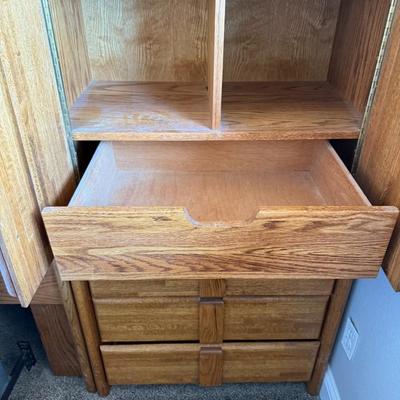 Sale Photo Thumbnail #374: Queen-size mattress and box spring set with a solid oak bedframe featuring integrated side cabinets, drawers, and overhead storage. Sturdy construction with a warm wood finish and ample built-in organization.
