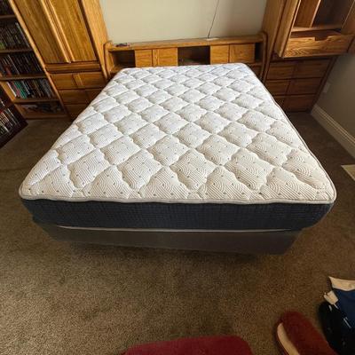 Sale Photo Thumbnail #371: Queen-size mattress and box spring set with a solid oak bedframe featuring integrated side cabinets, drawers, and overhead storage. Sturdy construction with a warm wood finish and ample built-in organization.