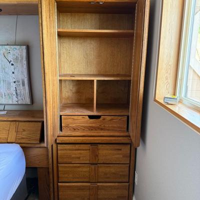 Sale Photo Thumbnail #373: Queen-size mattress and box spring set with a solid oak bedframe featuring integrated side cabinets, drawers, and overhead storage. Sturdy construction with a warm wood finish and ample built-in organization.