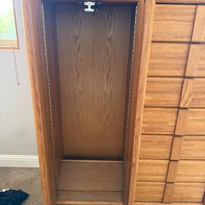 Sale Photo Thumbnail #410: Beautiful mid-century style oak dresser with dual cabinet doors on the left and 12 drawers on the right. Well-constructed with smooth-glide drawers and elegant wood grain finish. Ideal for master bedrooms or as a statement piece in a guest room.