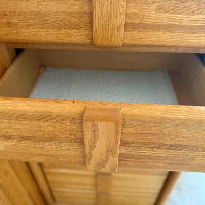 Sale Photo Thumbnail #411: Beautiful mid-century style oak dresser with dual cabinet doors on the left and 12 drawers on the right. Well-constructed with smooth-glide drawers and elegant wood grain finish. Ideal for master bedrooms or as a statement piece in a guest room.