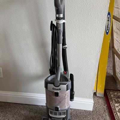 Sale Photo Thumbnail #419: Shark upright vacuum cleaner with Lift-Away feature for handheld use. Great suction power and rotating PowerFins brush roll—ideal for deep cleaning carpet and hard floors. Lightly used and in working condition.