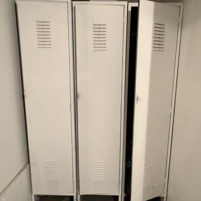 Sale Photo Thumbnail #425: Sturdy and functional metal locker unit with three tall compartments. Classic industrial design with vented doors, each with its own handle and latch. Shows minor cosmetic wear consistent with age but fully usable. Great for garage storage, mudroom organi