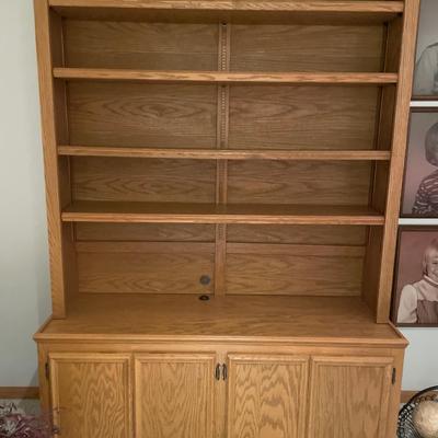 Tall wood shelving with storage on bottom