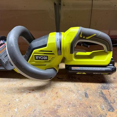 Sale Photo Thumbnail #446: High-power Ryobi 40V hedge trimmer with battery. Perfect for trimming thick branches or overgrowth.