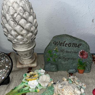 Sale Photo Thumbnail #108: Concrete statue, mosaic plant holder on wheels, garden rock and stakes, small planter with shoe holders