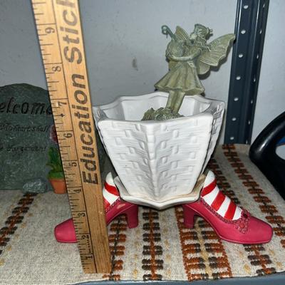 Sale Photo Thumbnail #111: Concrete statue, mosaic plant holder on wheels, garden rock and stakes, small planter with shoe holders