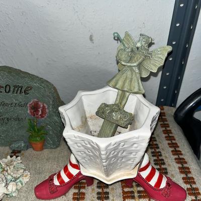 Sale Photo Thumbnail #107: Concrete statue, mosaic plant holder on wheels, garden rock and stakes, small planter with shoe holders