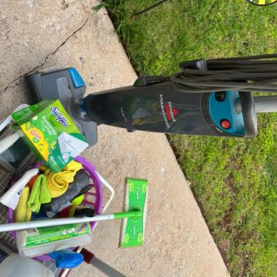 Sale Photo Thumbnail #294: Large metal basket full of cleaning supplies, Bissel Steam&Sweep, Swiffer with box of refills, microfiber towels and other cleaning items
