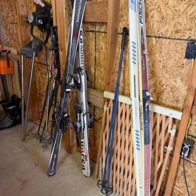 Sale Photo Thumbnail #18: Includes 3 pairs of skis with bindings and several poles. Brands include Dynastar, Fischer, and Atomic.