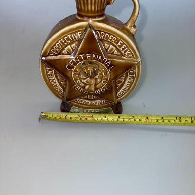 Sale Photo Thumbnail #45: Collectible whiskey bottle commemorating the Elks' centennial. Excellent condition, empty bottle.