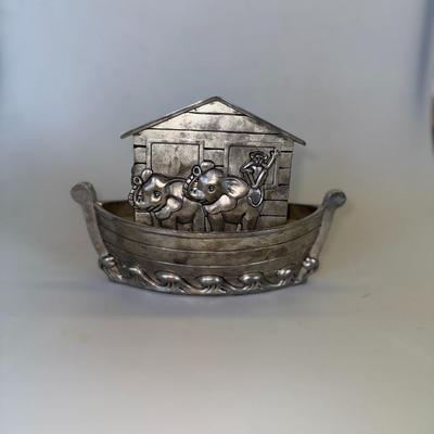 Sale Photo Thumbnail #68: Metal coin bank in the shape of Noah’s Ark with engraved animal details.