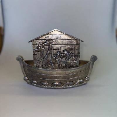 Sale Photo Thumbnail #69: Metal coin bank in the shape of Noah’s Ark with engraved animal details.