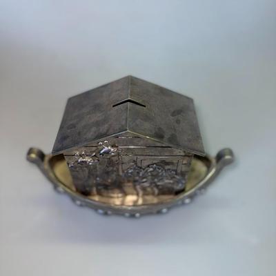 Sale Photo Thumbnail #70: Metal coin bank in the shape of Noah’s Ark with engraved animal details.