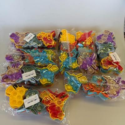 Sale Photo Thumbnail #78: Brightly colored butterfly-shaped pop toys, still in sealed packaging. Great for party favors or sensory play.