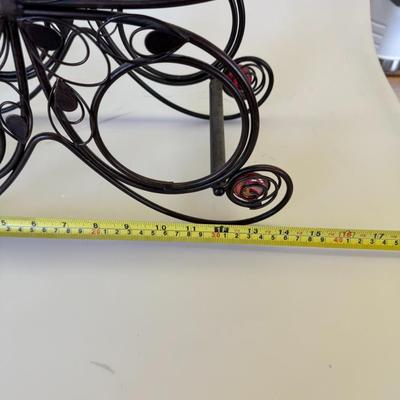 Sale Photo Thumbnail #122: Decorative black wire rack shaped like a butterfly with red glass bead accents. Holds plates or small trays.