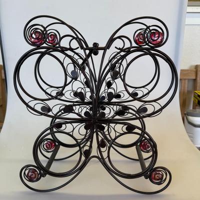 Sale Photo Thumbnail #120: Decorative black wire rack shaped like a butterfly with red glass bead accents. Holds plates or small trays.
