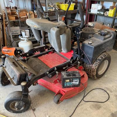 Sale Photo Thumbnail #146: Heavy-duty zero-turn mower. Some wear on the seat. Includes charger unit.