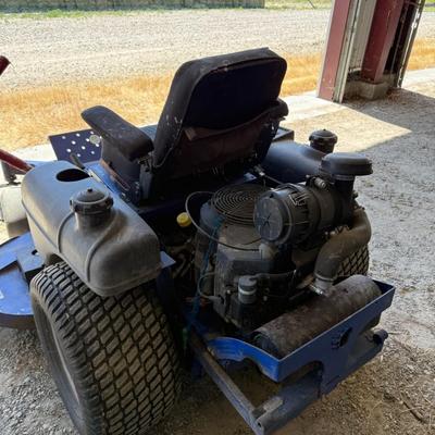 Sale Photo Thumbnail #150: This heavy-duty Dixon Grizzly mower features a commercial-grade zero-turn radius design, making it ideal for large property maintenance or landscaping use. It has dual lever steering, a wide cutting deck, and a comfortable padded seat. The controls are ea