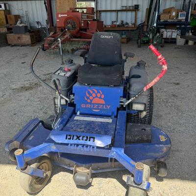 Sale Photo Thumbnail #148: This heavy-duty Dixon Grizzly mower features a commercial-grade zero-turn radius design, making it ideal for large property maintenance or landscaping use. It has dual lever steering, a wide cutting deck, and a comfortable padded seat. The controls are ea