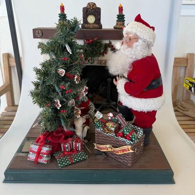 Sale Photo Thumbnail #183: Large Christmas display featuring a mechanical Santa at the fireplace surrounded by presents and a decorated tree. Lights up and possibly animates.