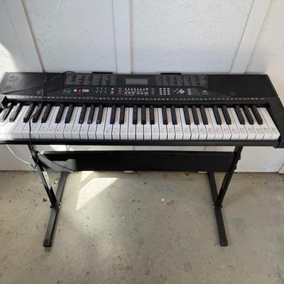 Sale Photo Thumbnail #196: Beginner-friendly keyboard with labeled keys, built-in rhythms, and stand. Fully functional with adapter included.