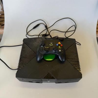 Sale Photo Thumbnail #200: Vintage first-generation Xbox console with a wired controller. Appears intact but untested. Great find for retro gaming enthusiasts or collectors.