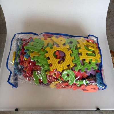 Sale Photo Thumbnail #212: Colorful foam interlocking letters and numbers in a zip bag. Great for playrooms, daycares, or preschool activities.