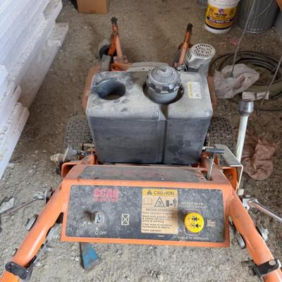 Sale Photo Thumbnail #230: Heavy-duty SCAG commercial mower with Kawasaki engine and 52" deck. Shows signs of use but is structurally solid. Ideal for landscapers or property owners needing tough mowing power.