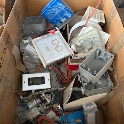 Sale Photo Thumbnail #233: Large lot of electrical supplies including switch plates, outlets, junction boxes, and miscellaneous wiring accessories. Great value for DIYers or electricians.