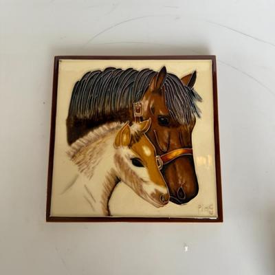 Sale Photo Thumbnail #279: Glossy raised ceramic wall plaque featuring a mother horse and foal. Signed “Ping.” Vintage western decor.