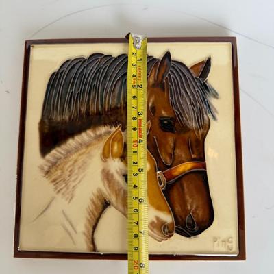 Sale Photo Thumbnail #281: Glossy raised ceramic wall plaque featuring a mother horse and foal. Signed “Ping.” Vintage western decor.