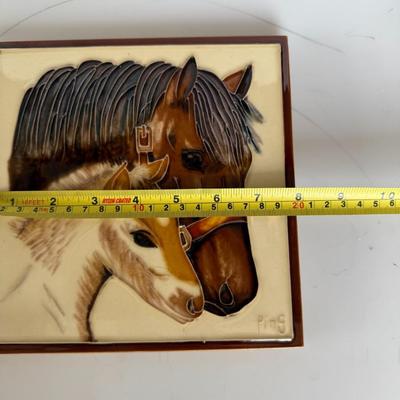 Sale Photo Thumbnail #282: Glossy raised ceramic wall plaque featuring a mother horse and foal. Signed “Ping.” Vintage western decor.