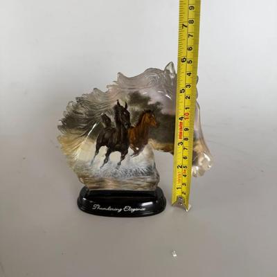 Sale Photo Thumbnail #291: Resin horse head sculpture with embedded imagery of running horses. Labeled “Thundering Elegance.”