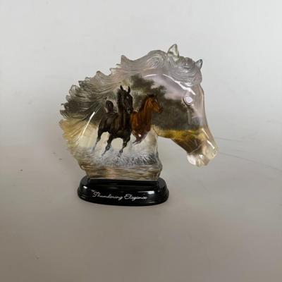 Sale Photo Thumbnail #289: Resin horse head sculpture with embedded imagery of running horses. Labeled “Thundering Elegance.”