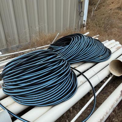 Sale Photo Thumbnail #375: wo large black/blue irrigation tubing coils. Great for farm, garden, or large-scale landscaping use.