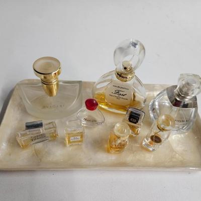 Sale Photo Thumbnail #246: DM70. Lot of Perfume Bottles on a Capiz Shell Tray

Dimensions: 24x36
Damage: Normal wear