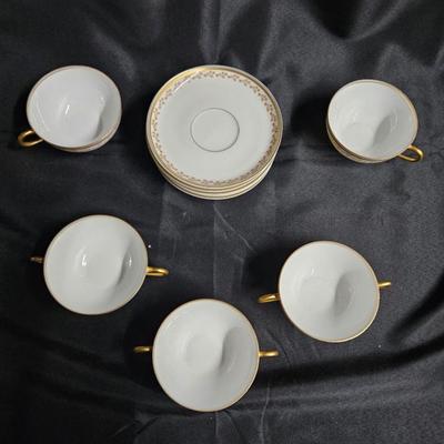 Sale Photo Thumbnail #376: Old Abby Limoges Porcelain Cups & Saucers
Description: 3 cream soup cups, 2 teacups, 5 saucers

Damage: Normal wear
