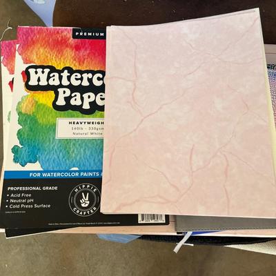 Sale Photo Thumbnail #729: Watercolor paper and other premium paper, several composition notebooks and journals, office supplies in plastic box, clipboard and planners