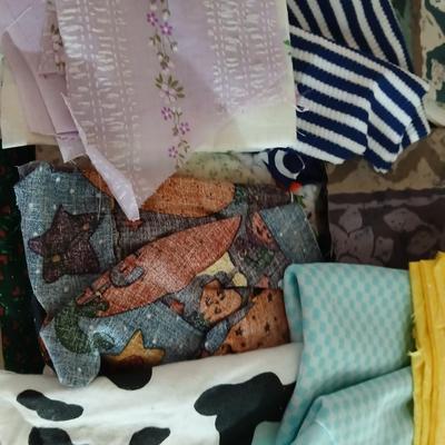 Large Lot of Assorted Cotton & Craft Fabrics – Novelty Prints, Yardage, Panels + Pattern Board in a storage tote