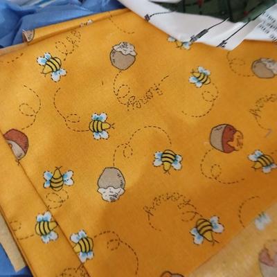 Large Lot of Assorted Cotton & Craft Fabrics – Novelty Prints, Yardage, Panels + Pattern Board in a storage tote