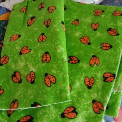 Large Lot of Assorted Cotton & Craft Fabrics – Novelty Prints, Yardage, Panels + Pattern Board in a storage tote