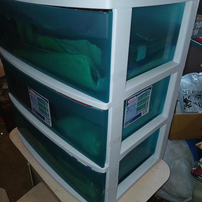 A three-drawer Sterilite cart filled with a festive variety of seasonal table linens and fabric decor