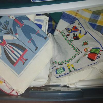 A three-drawer Sterilite cart filled with a festive variety of seasonal table linens and fabric decor