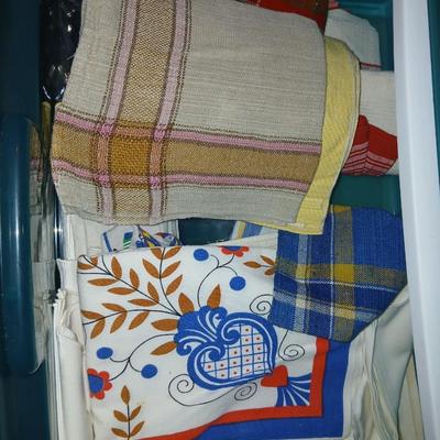 A three-drawer Sterilite cart filled with a festive variety of seasonal table linens and fabric decor
